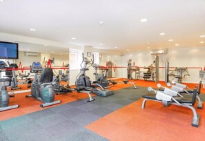 A gym with various exercise equipment, including treadmills, stationary bikes, and weight machines. - Luxury boutique apartment decorated to a high standard (Edinburgh)