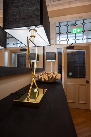 Ein modernes Interieur mit einer Reflektorlampe, einer Dekorationsschale und einer Tür mit Glasfenster.