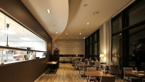 A modern restaurant with wooden flooring, large windows, and a variety of seating arrangements. - Breathtaking Stay w/Spa & Scenic Surroundings | Local Dining & Nature Spots (Wageningen)