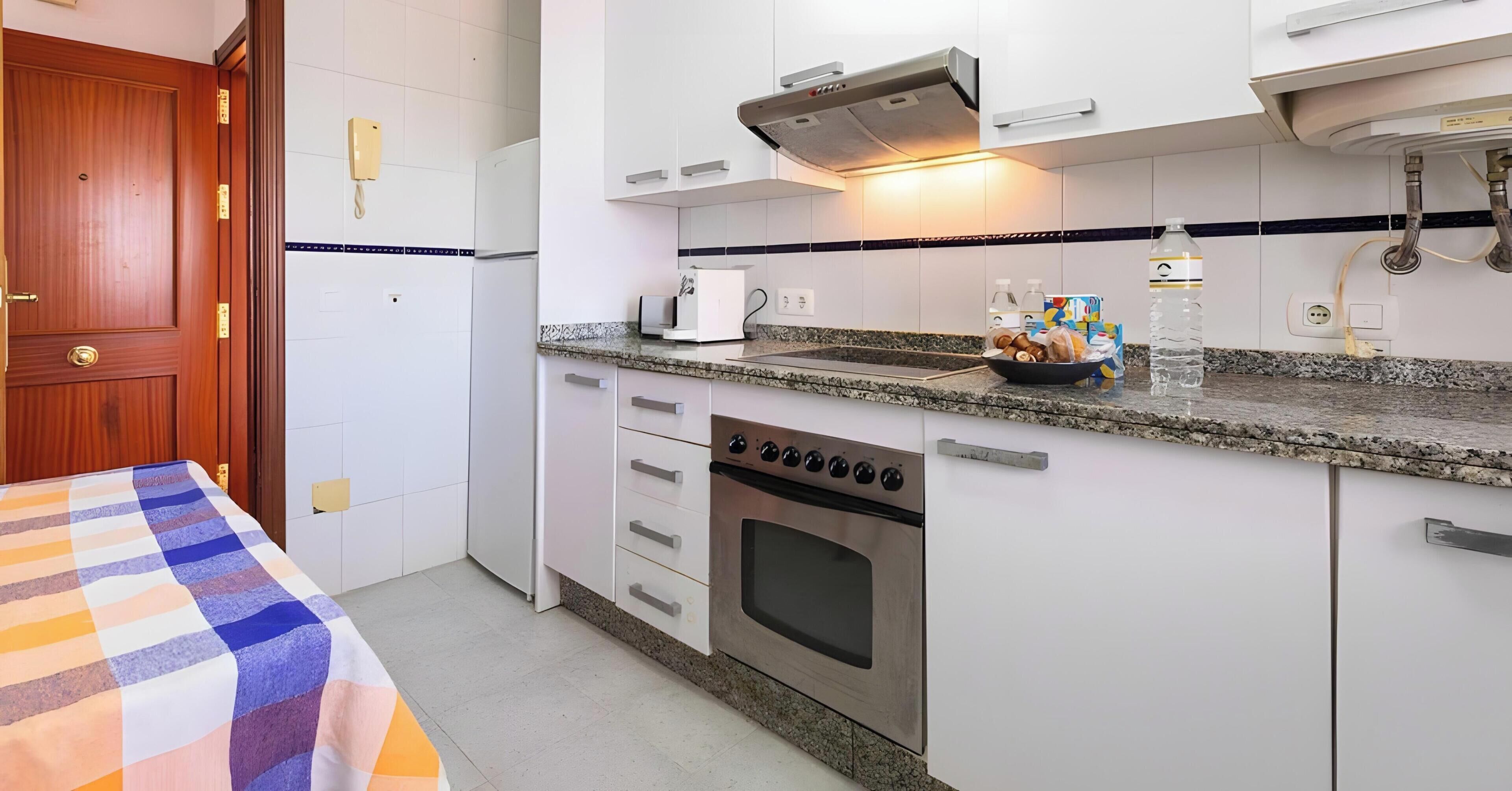 A modern kitchen with a built-in oven, a microwave, and a coffee maker.