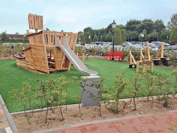 A playground with a wooden slide and climbing structures. - Relaxing Haven Near Tafelbergheide & Huizen Harbor | Local Dining & Landmarks (Huizen)
