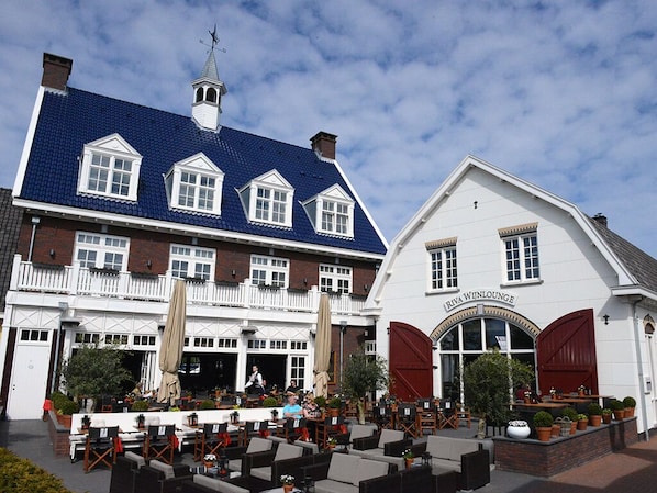 A traditional European building with a blue tiled roof and a white facade. - Spacious Suite w/Balcony | Breathtaking Reserves, Cultural Sights & Local Dining (Huizen)