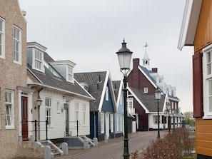 A street with traditional European architecture, including a church steeple and a street lamp. - Perfect Urban Stay | Coronel Karting & Huizer Museum & Goois Nature Reserve (Huizen)