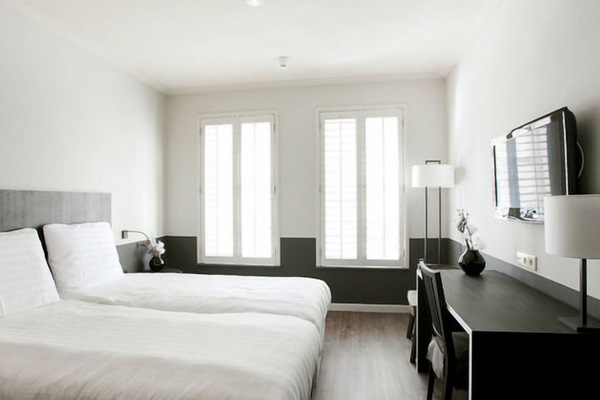 Unwind in crisp linens with desk and wall-mounted TV.