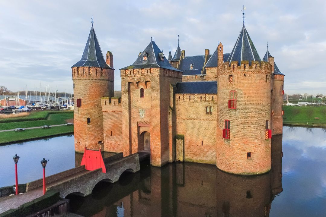 A historic castle with multiple towers and a moat.