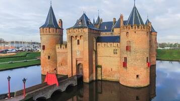 A historic castle with multiple towers and a moat.