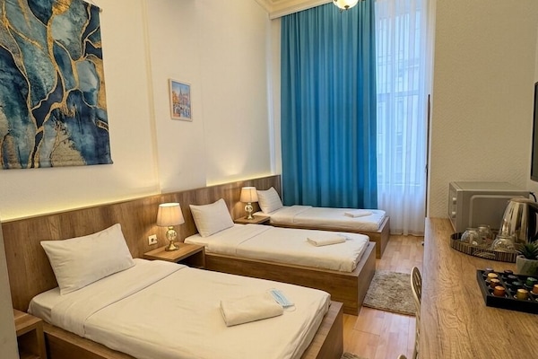 Deluxe Triple Room | In-room safe, desk, laptop workspace, blackout drapes