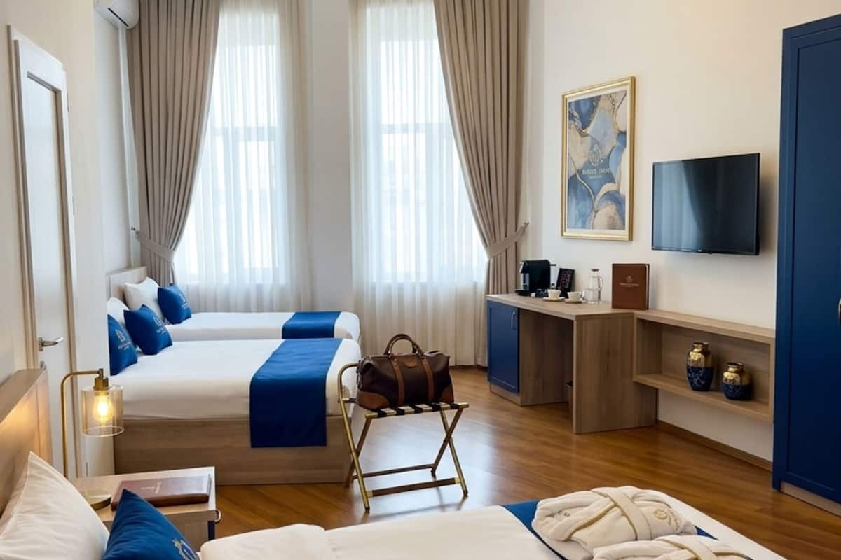 Family Quadruple Room, Balcony, City View | In-room safe, desk, laptop workspace, blackout curtains