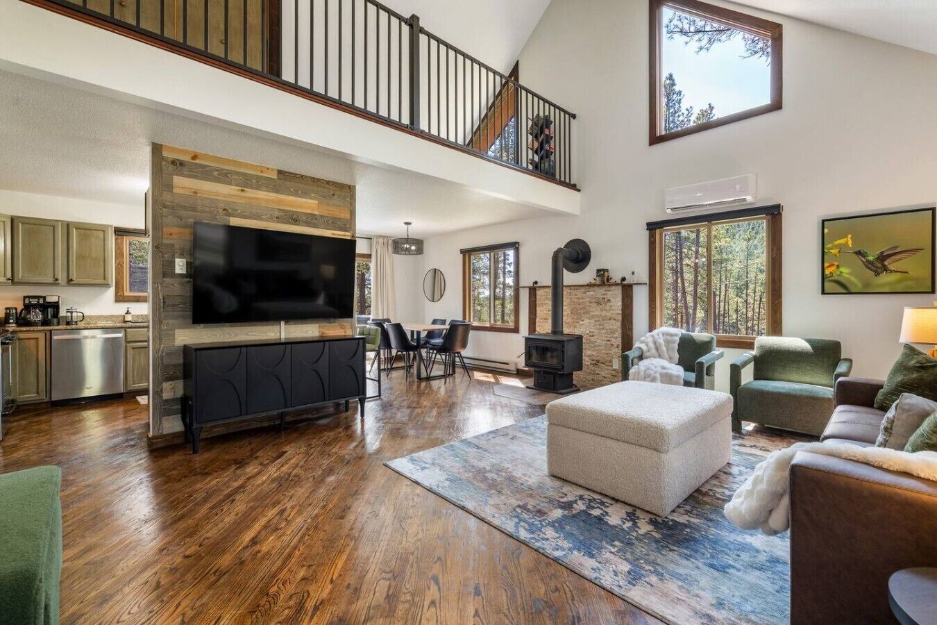 A spacious living area with a fireplace, a dining table, and a television.