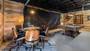 A room with a pool table, a poker table, and a billiards rack. - Forest Road Haven: 3 King BR-GameRoom-HotTub-Sauna (Rapid City)