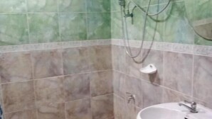 A bathroom with a shower, a sink, and a small stool. - Room-big Charming Suite With Balcony in (Pattaya)