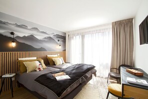 A modern bedroom with a bed, bedside tables, a desk, and a large window with curtains. - Super Venosc | T3 à 100m des pistes, 50m télésiège (MONT-DE-LANS)