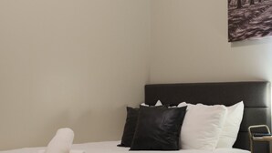 A hotel room with two beds, a headboard, and a painting on the wall. - Stylish Downtown Stay | Pool, Gym, Valet Parking (Dallas)