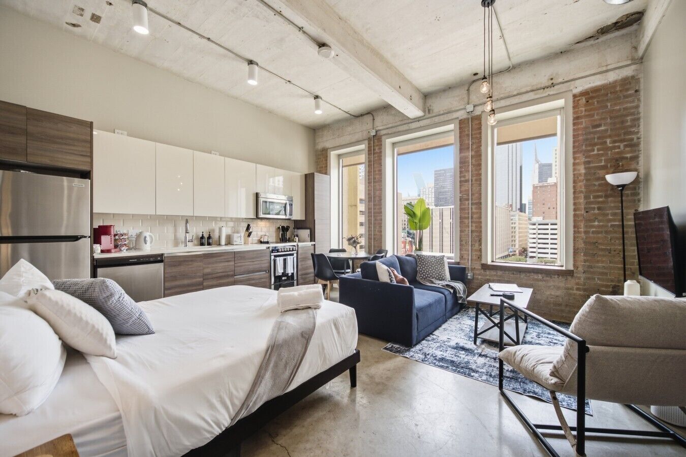 A modern apartment with a kitchen, dining area, and living room.