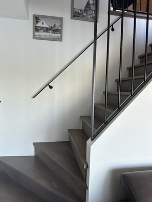 A staircase with a metal handrail and wooden steps. - A little paradise for all seasons on the shores of Lake St-Alexis (Saint-Alexis-des-Monts)