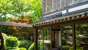 A traditional building with a tiled roof and wooden lattice windows.