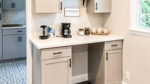 A kitchen with a coffee bar, cabinets, and a window. - Tucked away in Tucker (Tucker)