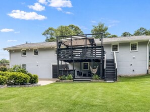 A two-story house with a covered patio area, a staircase, and a hammock. - Tucked away in Tucker (Tucker)