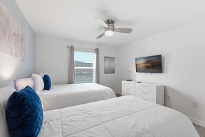 A bedroom with two beds, a ceiling fan, a window with blinds, a dresser, and a painting on the wall. - Family Friendly Home, Private Pool, Near Disney (Kissimmee)