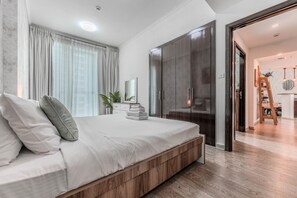 A modern bedroom with a large bed, a wardrobe, and a view into the living area. - HAVN - 2 Bed in Dubai Marina, 5 mins to Tram (Dubai)