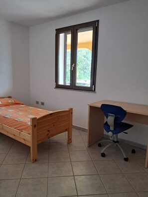 A room with a bed, a desk, and a window. - Casa Rurale - S'Olivare di Filieri (Dorgali)