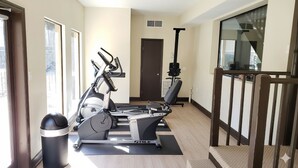 A home gym with stationary bikes, a treadmill, and a rowing machine. - Gainesville 2BR/2BA Comfort Stay (Gainesville)