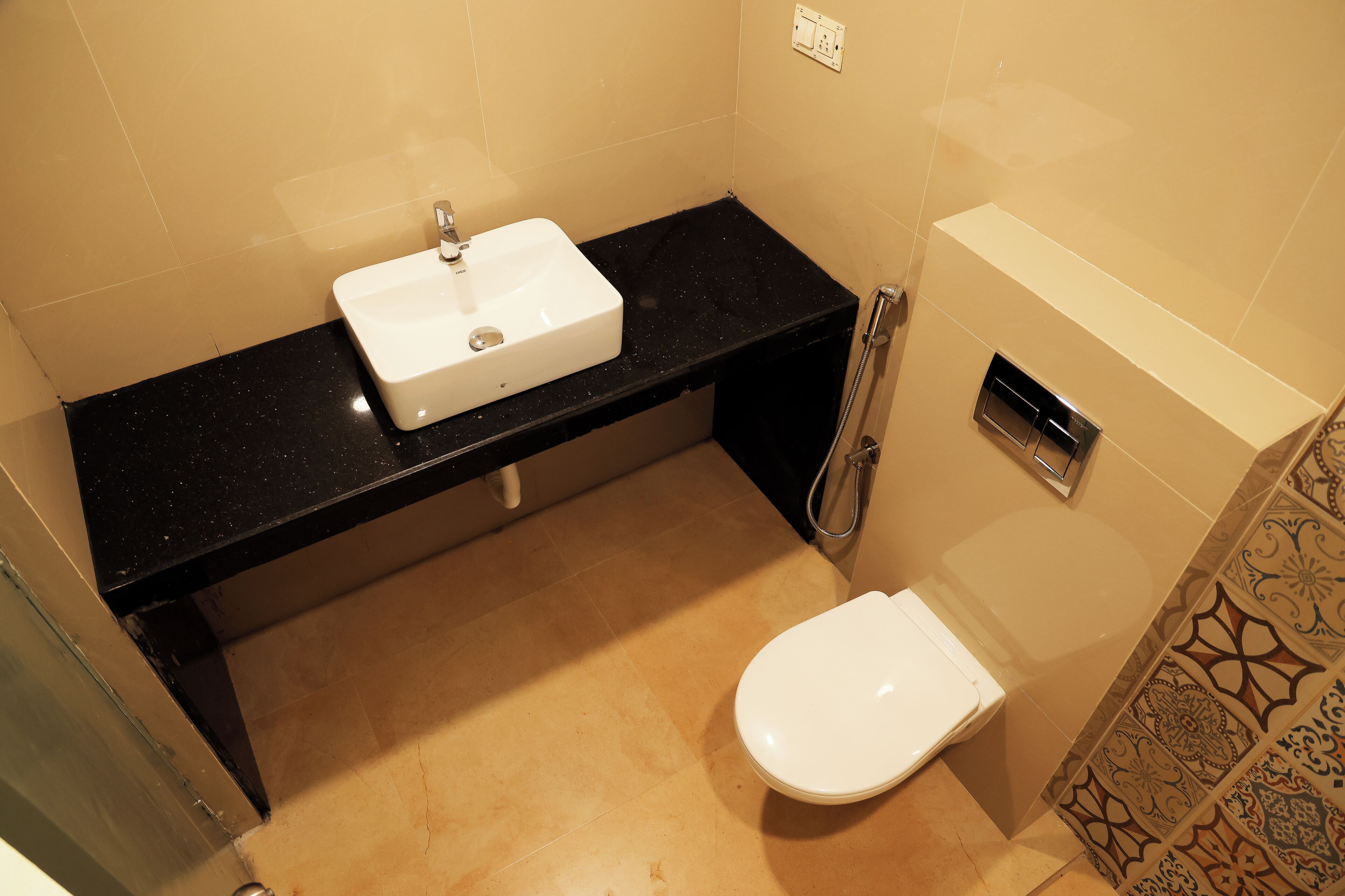 A bathroom with a white sink, a toilet, and a shower.