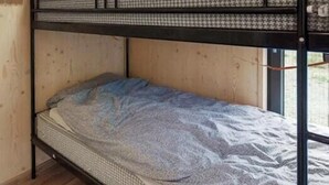 A bunk bed with a lower bunk and a mattress on the upper bunk. - Modern cabin by Krøderfjorden near Norefjell (Noresund)