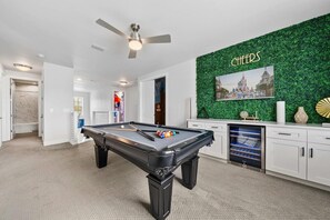 A pool table in a room with a green wall and a ceiling fan. - The Gathering Spot - Six Bedroom House, Sleeps 14 (Lake Buena Vista)