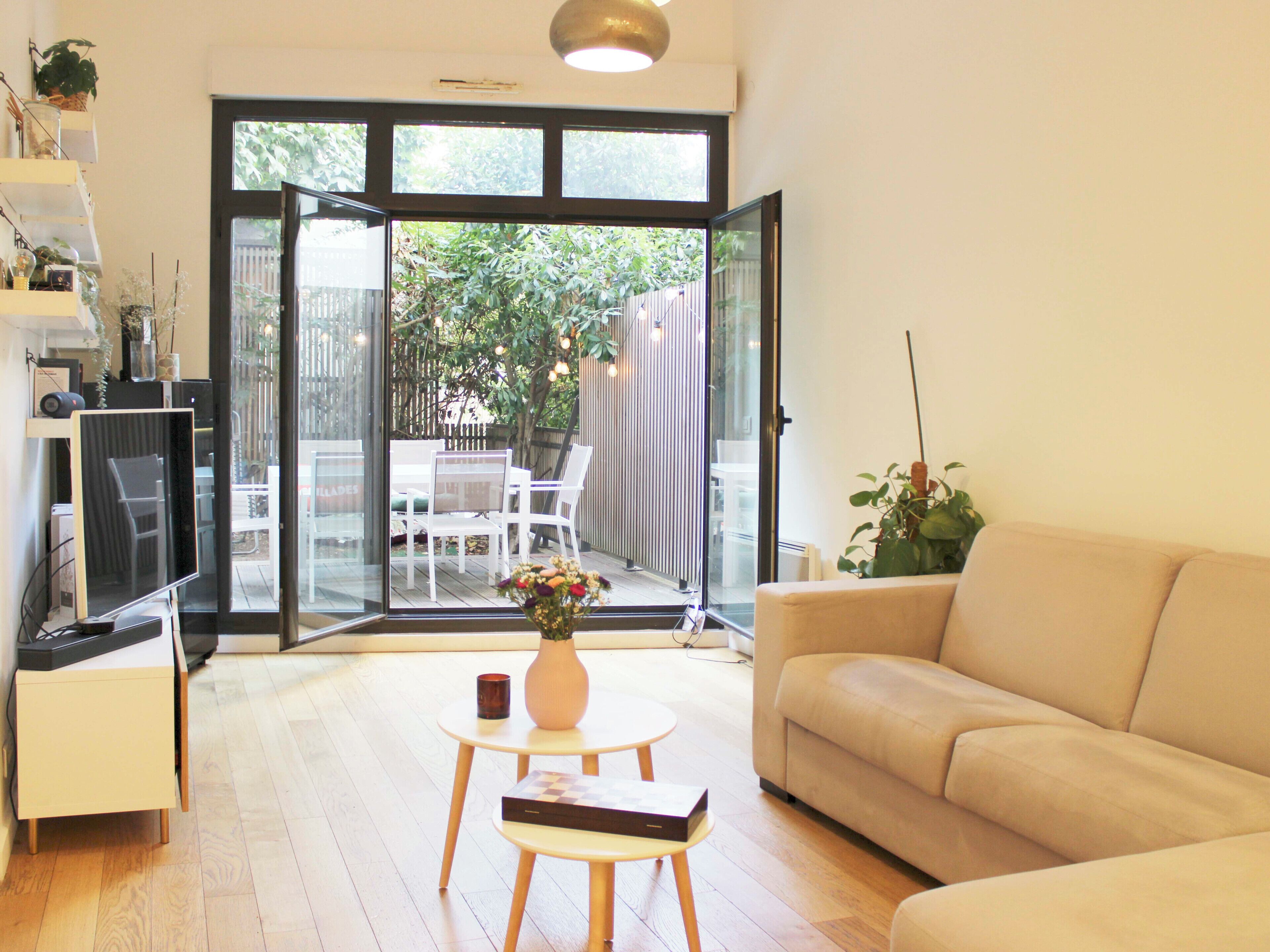 A modern living room with a sofa, a coffee table, and a TV.