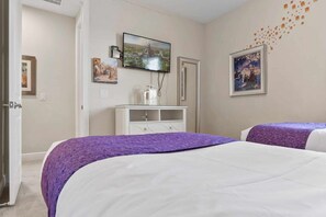 A hotel room with two beds, a television, a dresser, and artwork on the walls. - Private Pool and Jetted Tub/Private Cinema/Close to Disney/Spacious pool deck (Kissimmee)