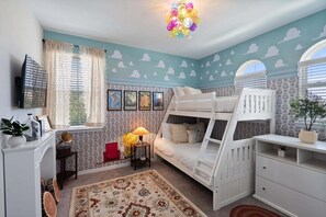 A child's bedroom with bunk beds, a desk, a TV, and decorative wall art. - Galaxy Getaway - Nine Bedroom House, Sleeps 22 (Kissimmee)