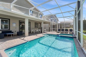 A pool area with a covered patio, seating, and a sign indicating pool rules. - Linksview Villa - Eight Bedroom House, Sleeps 22 (Kissimmee)