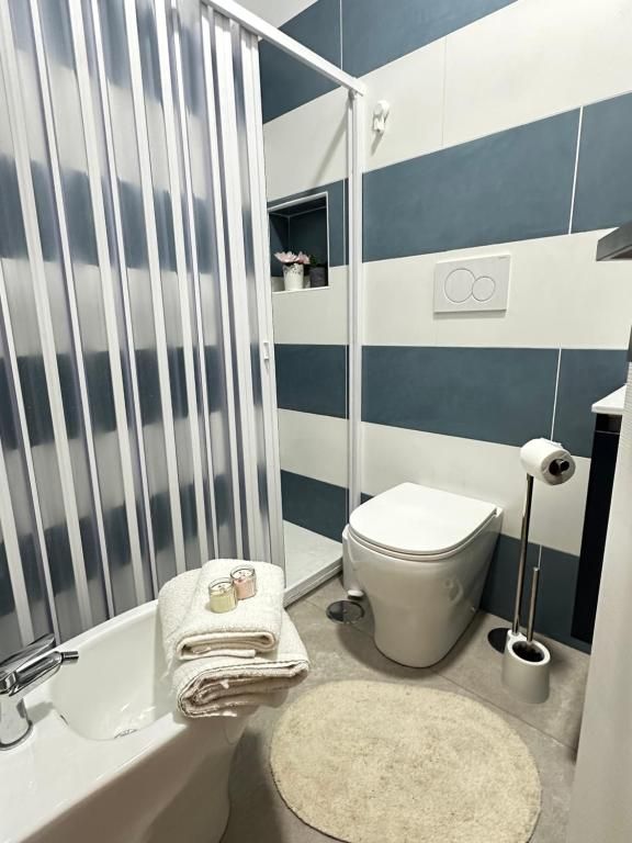 A bathroom with a bathtub, toilet, and shower.