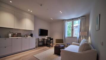 A modern living space with a kitchen, dining area, and seating area.