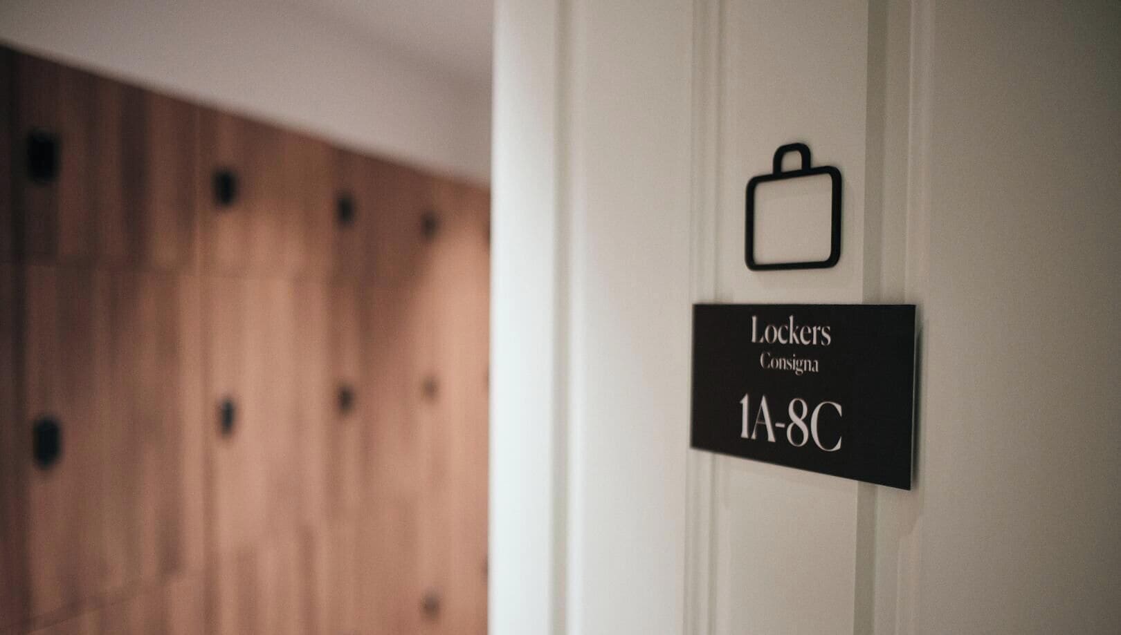 A wall-mounted sign indicating a locker area with the number 1A-8C.