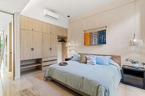 A bedroom with a bed, wardrobe, hanging curtains, and pendant lights. - Yáax K'iin: Poolside Oasis + Free E-Bikes (Playa del Carmen)