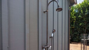 A metal showerhead attached to a wall with a vertical pipe and a valve. - Luxury Capitola Retreat | Hot Tub | Blocks to Sand (Capitola)