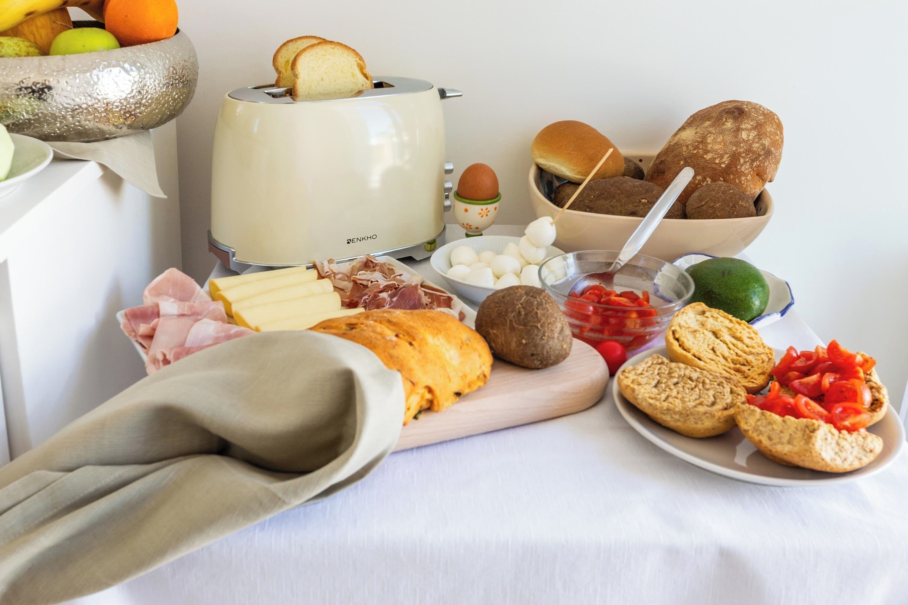 A variety of food items including bread, cheese, and vegetables on a table.