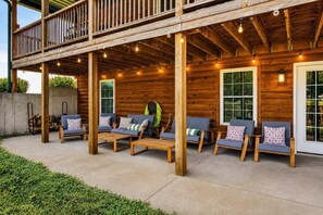 A wooden deck with outdoor seating and a covered area.