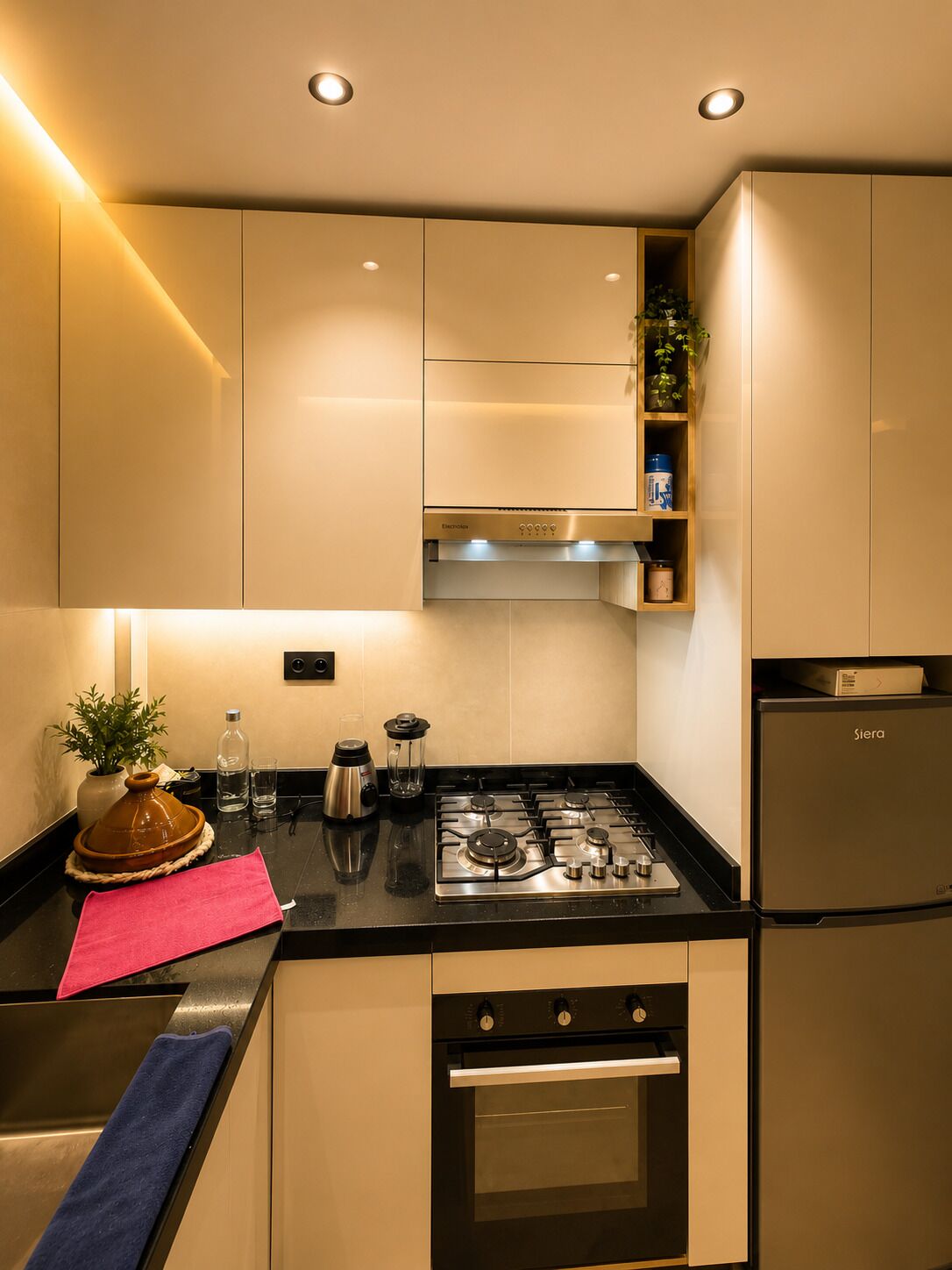 A modern kitchen with a gas stove, oven, and built-in cabinets.