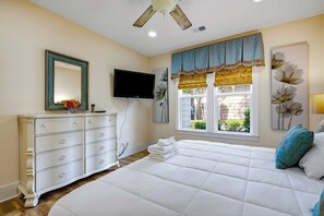A bedroom with a bed, a dresser, a television, and a window with a view of the outside. - 624 Ratoon Lane - Spacious Vacation Home in North Myrtle Beach! (North Myrtle Beach)