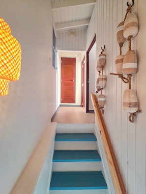 A staircase with blue steps leading to a wooden door.