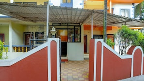 A building entrance with a tiled floor, a metal gate, and a covered area with a roof. - Saver Double Crystal Holiday Homes (Calangute)
