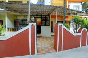 A building entrance with a tiled floor, a metal gate, and a covered area with a roof. - Saver Double Crystal Holiday Homes (Calangute)