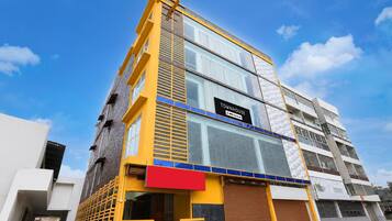 A multi-story building with a sign indicating it is a serviced apartment.