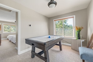 A room with a pool table, a bed, a window with blinds, and a ceiling fan. - Sunlit Mountain Retreat Near Lakes & Ski Fun (Arnold)