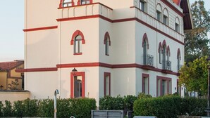 A large building with a swimming pool in front.