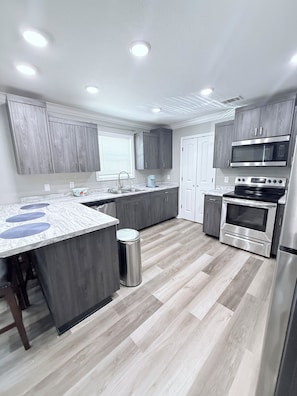 A modern kitchen with a central island, built-in appliances, and a clean, contemporary design.