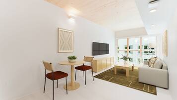 A modern living room with a sofa, a TV, and a dining area with chairs and a table.